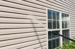 Power washing siding of a house